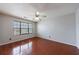 Bedroom featuring hardwood floors, ceiling fan, and a window with horizontal blinds at 4844 W Park Cir # 4844, College Park, GA 30349