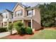 Charming two-story townhome with brick accents, manicured landscaping, and a welcoming front porch at 4844 W Park Cir # 4844, College Park, GA 30349