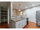 A kitchen featuring granite countertops, stainless steel appliances, and white cabinets at 4844 W Park Cir # 4844, College Park, GA 30349