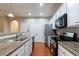 Bright kitchen featuring white cabinetry, granite countertops, and stainless steel appliances at 4844 W Park Cir # 4844, College Park, GA 30349