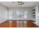 Bright living room with hardwood floors, a ceiling fan, and a view of the backyard at 4844 W Park Cir # 4844, College Park, GA 30349