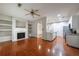 Open-concept living room with fireplace, built-ins, hardwood floors, and easy kitchen access at 4844 W Park Cir # 4844, College Park, GA 30349