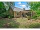 Back exterior showcasing the covered patio, mature landscaping, and architectural details of the home at 55 Fox Chase, Covington, GA 30016