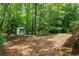 Large, wooded backyard featuring a storage shed and plenty of space for outdoor activities at 55 Fox Chase, Covington, GA 30016