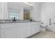 Modern bathroom with dual sinks, granite countertop, and white cabinets at 55 Fox Chase, Covington, GA 30016