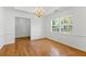 Dining room with hardwood floors, chandelier, and views from a large window at 55 Fox Chase, Covington, GA 30016