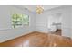 Dining room with chandelier, hardwood floors, and natural light from large window at 55 Fox Chase, Covington, GA 30016