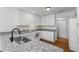 White kitchen featuring granite countertops, modern appliances, and white backsplash at 55 Fox Chase, Covington, GA 30016