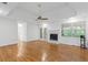 Bright living room features a fireplace, hardwood floors, and tray ceiling at 55 Fox Chase, Covington, GA 30016