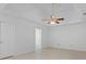 Spacious main bedroom with tiled floors, ceiling fan, tray ceiling, and ensuite bathroom at 55 Fox Chase, Covington, GA 30016