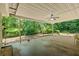 Covered patio featuring a ceiling fan and a picturesque view of the lush, wooded backyard at 55 Fox Chase, Covington, GA 30016