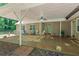 Covered patio area with concrete flooring, ceiling fan, and a view of the wooded backyard at 55 Fox Chase, Covington, GA 30016