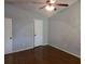 Vaulted ceiling bedroom with hardwood floors, ceiling fan, and standard closet at 5826 Par Four Ct, Lithonia, GA 30038