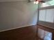 Corner bedroom featuring hardwood floors, a ceiling fan, and a large window at 5826 Par Four Ct, Lithonia, GA 30038
