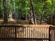 A beautiful outdoor space featuring a wooden deck surrounded by lush trees at 5826 Par Four Ct, Lithonia, GA 30038