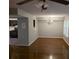Open-concept dining room featuring hardwood floors, modern lighting fixture, and view into the kitchen at 5826 Par Four Ct, Lithonia, GA 30038