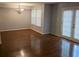 Bright dining area featuring hardwood floors, a modern chandelier, and sliding glass doors at 5826 Par Four Ct, Lithonia, GA 30038