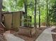 Exterior view of townhomes surrounded by mature trees and landscaping with walking path at 5826 Par Four Ct, Lithonia, GA 30038