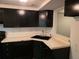 Kitchen featuring black appliances, updated black sink and faucet with matching dark cabinets at 5826 Par Four Ct, Lithonia, GA 30038