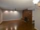 Spacious living room with beautiful hardwood floors, wood paneling and inviting fireplace for a cozy atmosphere at 5826 Par Four Ct, Lithonia, GA 30038