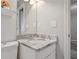Modern bathroom vanity featuring marble countertop, stylish mirror, and updated fixtures at 107 Woodberry Ct, Woodstock, GA 30188