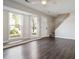 Bright living room featuring a staircase, wood flooring, and neutral paint and large bay windows at 107 Woodberry Ct, Woodstock, GA 30188