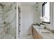 Elegant bathroom with a marble shower, modern fixtures, and a vanity with double sinks at 1954 8Th St, Chamblee, GA 30341