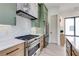 Modern kitchen featuring stainless steel range and marble countertops, accented by green cabinetry at 1954 8Th St, Chamblee, GA 30341