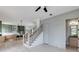 Open-concept living room leads to a modern kitchen, staircase with black iron spindles, and a powder room at 1954 8Th St, Chamblee, GA 30341