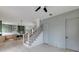 Open-concept living room featuring a modern kitchen, light wood floors, and a staircase with black iron spindles at 1954 8Th St, Chamblee, GA 30341
