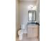 Stylish powder room featuring a marble countertop, elegant lighting, and contemporary fixtures at 1954 8Th St, Chamblee, GA 30341