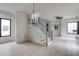 Beautiful stairway with open living area, light wood floors, and modern black chandelier at 1954 8Th St, Chamblee, GA 30341