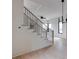 Modern staircase with oak treads, black metal railing, and open living area at 1954 8Th St, Chamblee, GA 30341