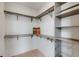 Organized walk-in closet with ample shelving, custom hanging rods, and drawer organizers for optimal storage at 1954 8Th St, Chamblee, GA 30341