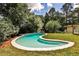 Serene backyard with a uniquely shaped pool, grassy lawn, and a tranquil setting at 2568 Laurelwood Rd, Atlanta, GA 30360