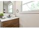 Bathroom with modern vanity, mirror, and a large window offering natural light at 2568 Laurelwood Rd, Atlanta, GA 30360