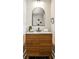 Modern bathroom with stylish vanity, arched mirror, and sleek fixtures at 2568 Laurelwood Rd, Atlanta, GA 30360