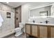 Bright bathroom features double sinks, an LED mirror, and a modern walk-in shower with designer tile at 2568 Laurelwood Rd, Atlanta, GA 30360