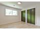 Bedroom with clean lines, a window, and dual closet doors at 2568 Laurelwood Rd, Atlanta, GA 30360