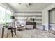 Stylish bedroom featuring a modern accent wall, comfortable seating, and ample natural light at 2568 Laurelwood Rd, Atlanta, GA 30360