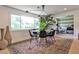 Elegant dining room featuring a round table, stylish rug, and large windows at 2568 Laurelwood Rd, Atlanta, GA 30360