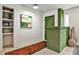Inviting entryway featuring a vibrant green accent wall, built-in shelving, and stylish decor at 2568 Laurelwood Rd, Atlanta, GA 30360