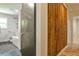 Hallway with a half-bath, wood accent wall, and modern features providing a unique architectural design at 2568 Laurelwood Rd, Atlanta, GA 30360