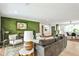 Cozy living room with a green brick accent wall, fireplace, and comfortable seating arrangement at 2568 Laurelwood Rd, Atlanta, GA 30360