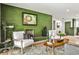 Stylish living room features a unique green brick fireplace and ample seating at 2568 Laurelwood Rd, Atlanta, GA 30360