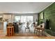 The living room features hardwood floors, a gray sofa, stylish chairs and a decorative green brick wall at 2568 Laurelwood Rd, Atlanta, GA 30360