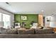 Spacious living room features hardwood floors, two sofas, a stylish green brick fireplace, and bright lighting at 2568 Laurelwood Rd, Atlanta, GA 30360