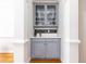 Stylish bar area with gray cabinetry, elegant glass shelving, sink, and chic backsplash at 2610 Oglethorpe Ne Cir, Brookhaven, GA 30319