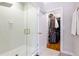 Elegant bathroom showcasing a glass shower and walk-in closet with custom shelving at 2610 Oglethorpe Ne Cir, Brookhaven, GA 30319