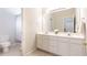 Bright bathroom featuring double vanity, lots of cabinet storage, and a large well-lit mirror at 2610 Oglethorpe Ne Cir, Brookhaven, GA 30319